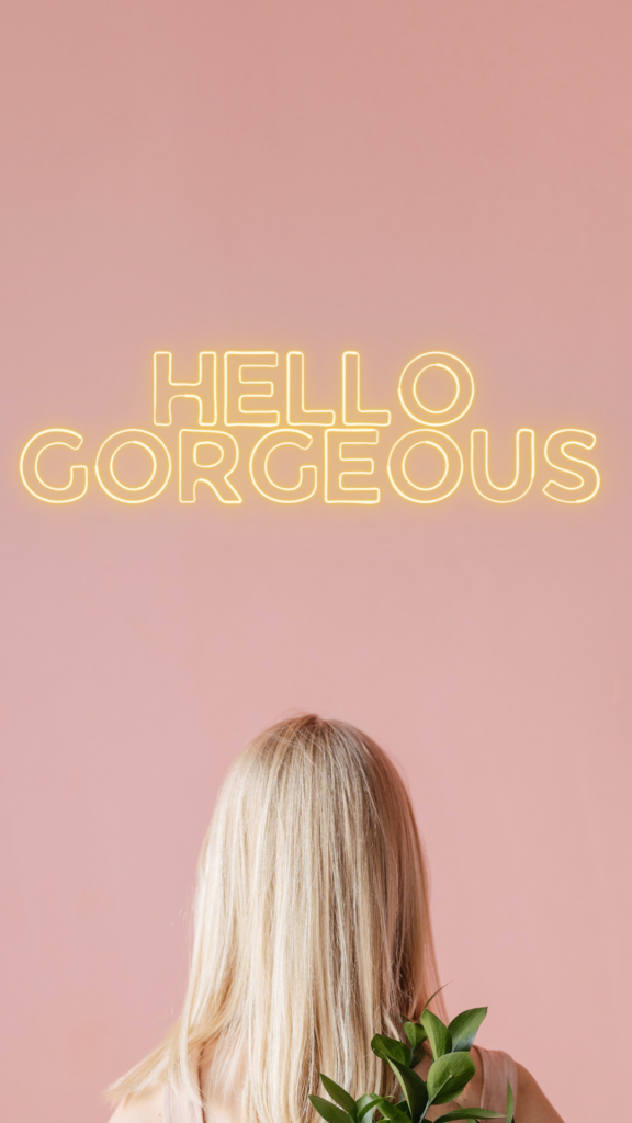 LED Neon Sign Ideas for Beauty Salons - Photo of the back of a woman's head facing a pink wall. The woman has shoulder length blonde hair. There is a mockup for an LED sign above her reading 'hello gorgeous' in a warm white minimalist outline font. 