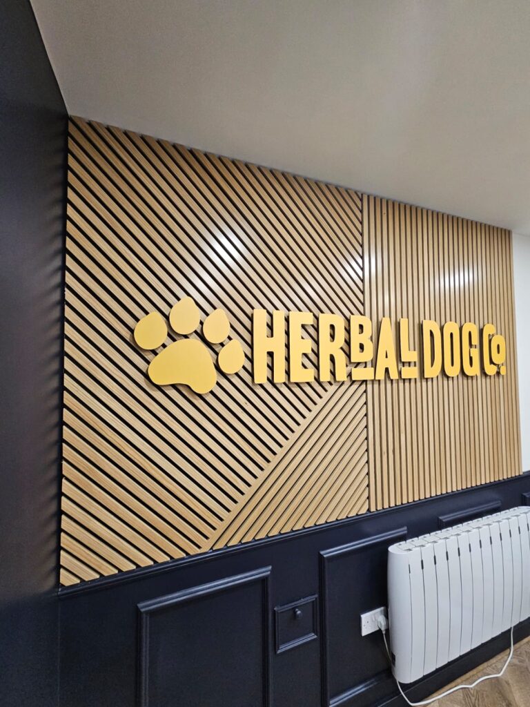 Herbal Dog Co wood slat wall with acrylic lettering